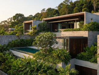 Luxury villa exterior with tiered stone walls and lush tropical landscaping designed for maximum guest privacy.